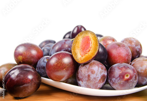 Photo: fresh plums on wooden table fresh plums on wooden table