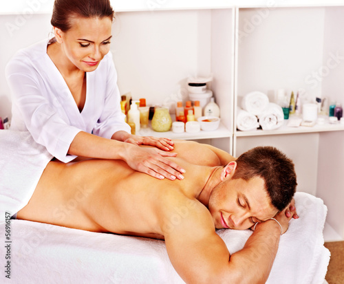 Photo: Man getting massage in spa. Man getting massage in spa.