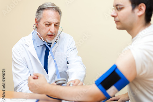 Photo: Doctor and patient with blood pressure meter. Health care. Doctor and patient with blood pressure meter. Health care.