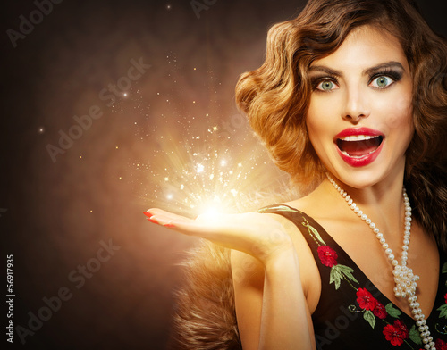 Photo: Retro Woman with Holiday Magic Gift in her Hand Retro Woman with Holiday Magic Gift in her Hand