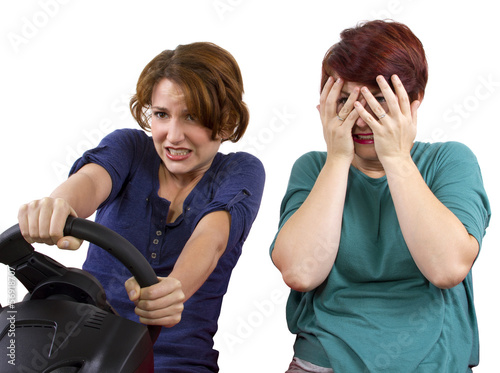 Photo: reckless driver and scared female passenger on white background reckless driver and scared female passenger on white background