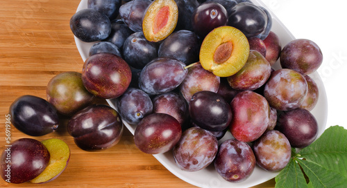 Photo: fresh plums on wooden table fresh plums on wooden table