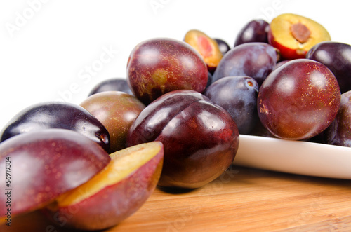 Photo: fresh plums on wooden table fresh plums on wooden table
