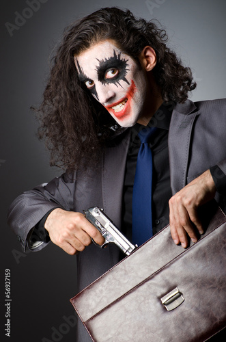 Photo: Joker with gun and briefcase Joker with gun and briefcase