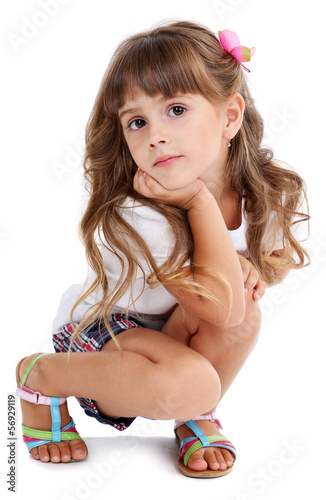 Photo: Little girl posing isolated on white Little girl posing isolated on white