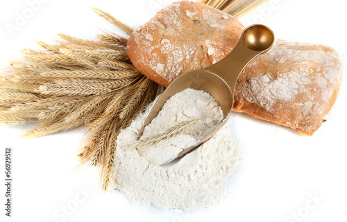 Photo: The wholemeal flour in scoop isolated on white The wholemeal flour in scoop isolated on white