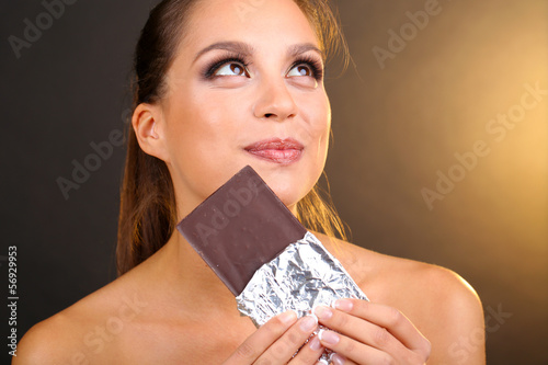 Photo: Portrait of beautiful young girl with chocolate Portrait of beautiful young girl with chocolate