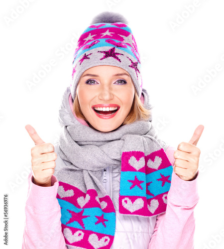Photo: Happy adult girl in winter clothes with thumbs up Happy adult girl in winter clothes with thumbs up