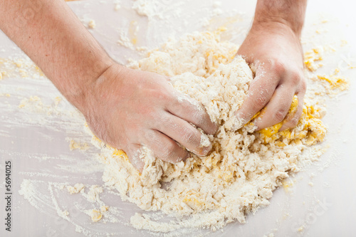 Photo: man hands kneading a dough man hands kneading a dough