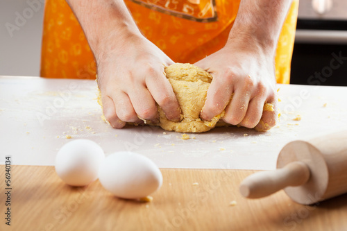 Photo: man hands kneading a dough man hands kneading a dough