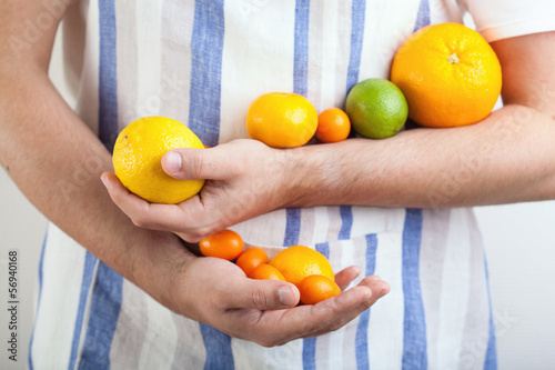 Photo: man hands holding citrus fruits man hands holding citrus fruits