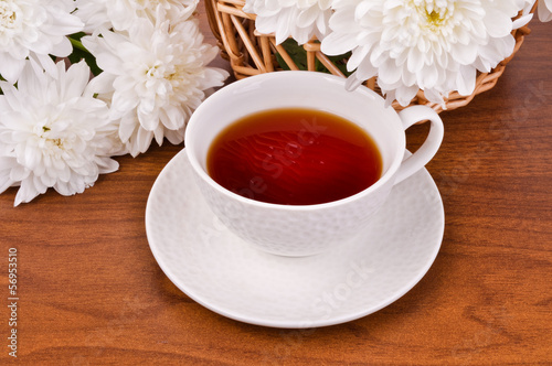 Photo: A mug of tea and white chrysanthemums A mug of tea and white chrysanthemums