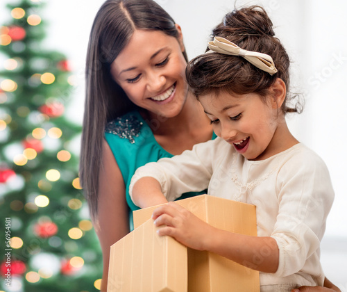 Photo: happy mother and child girl with gift box happy mother and child girl with gift box
