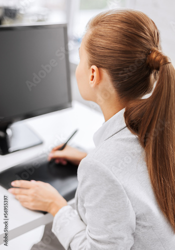 Photo: businesswoman with drawing tablet in office businesswoman with drawing tablet in office