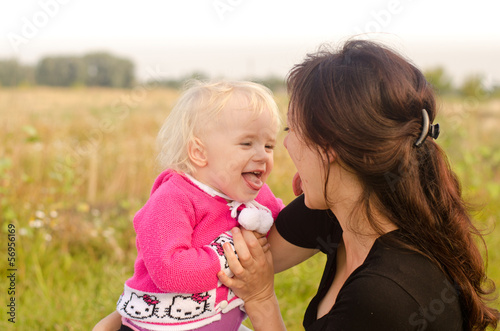 Photo: Happy young mother and child having rest near the river Happy young mother and child having rest near the river