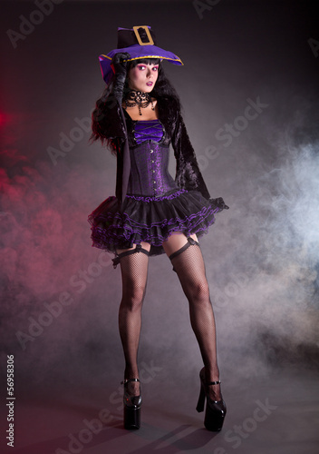 Photo: Pretty witch in purple and black gothic Halloween costume Pretty witch in purple and black gothic Halloween costume