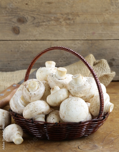 Photo: organic mushrooms (champignons) in a basket organic mushrooms (champignons) in a basket