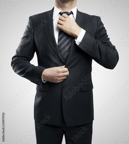 Photo: man adjusts his tie man adjusts his tie