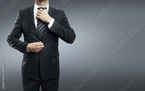 Photo: businessman adjusts his tie businessman adjusts his tie