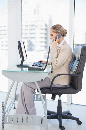 Photo: Focused blonde businesswoman on the phone Focused blonde businesswoman on the phone