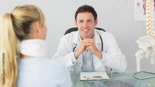 Photo: Smiling doctor having an appointment with a patient Smiling doctor having an appointment with a patient