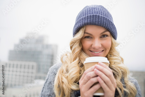 Photo: Cheerful pretty blonde having coffee outdoors Cheerful pretty blonde having coffee outdoors