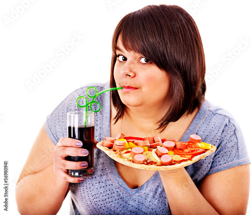 Photo: Woman eating fast food. Woman eating fast food.
