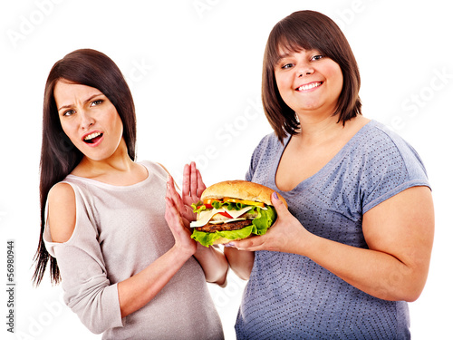 Photo: Women eating hamburger. Women eating hamburger.