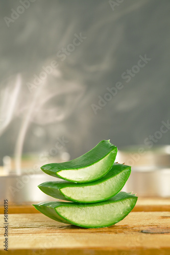 Photo: Aromatherapy with fresh aloe vera slices on wooden. Aromatherapy with fresh aloe vera slices on wooden.