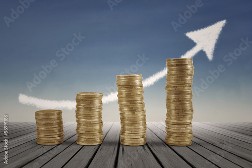 Photo: Business graph with arrow and coins Business graph with arrow and coins