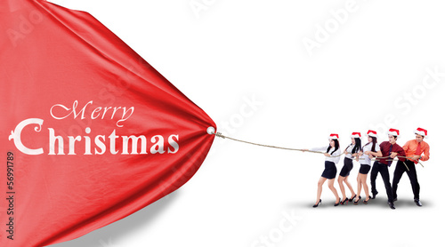 Photo: Businesspeople is pulling christmas banner isolated Businesspeople is pulling christmas banner isolated