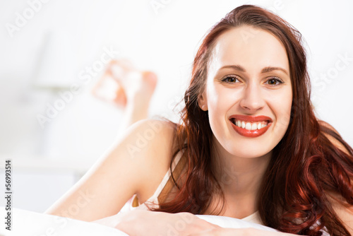 Photo: portrait of a young woman in the bedroom portrait of a young woman in the bedroom