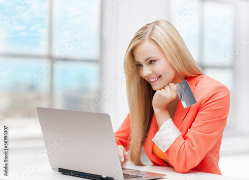 Photo: happy teenage girl with laptop and credit card happy teenage girl with laptop and credit card