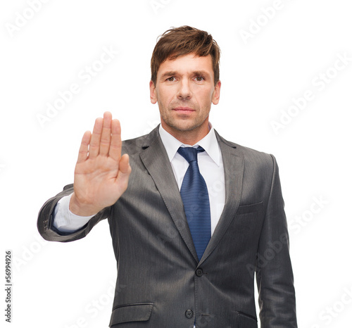 Photo: attractive buisnessman making stop gesture attractive buisnessman making stop gesture