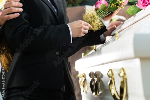 Photo: Mourning People at Funeral with coffin Mourning People at Funeral with coffin
