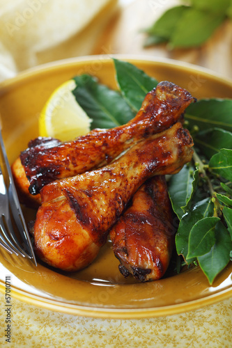 Photo: Roast chicken legs with lemon and herbs on plate. Roast chicken legs with lemon and herbs on plate.