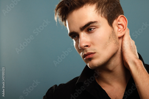 Photo: Trendy young man in black shirt, portrait of sexy fashion boy lo Trendy young man in black shirt, portrait of sexy fashion boy lo