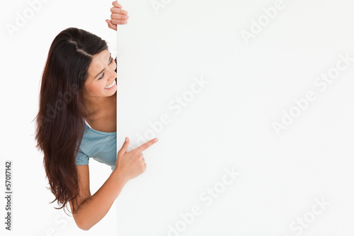 Photo: Gorgeous woman pointing at a board Gorgeous woman pointing at a board