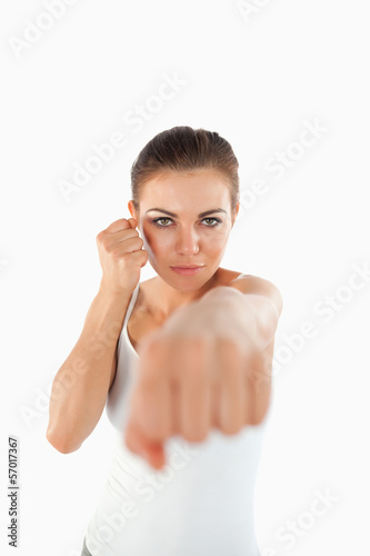 Photo: Female martial arts fighter striking with her fist Female martial arts fighter striking with her fist