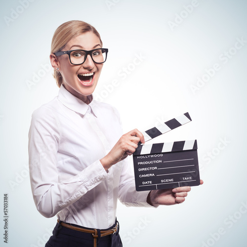 Photo: woman holding clapper board in her hands woman holding clapper board in her hands