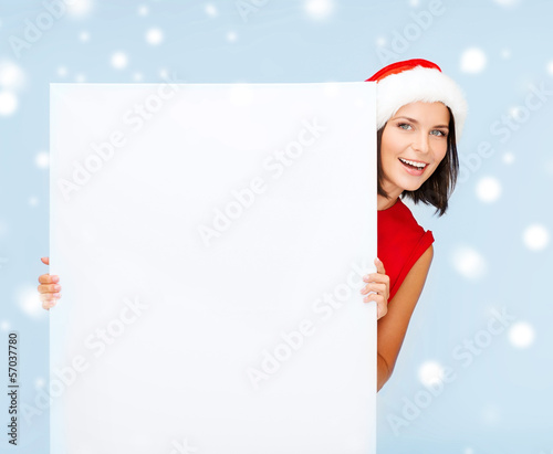 Photo: woman in santa helper hat with blank white board woman in santa helper hat with blank white board