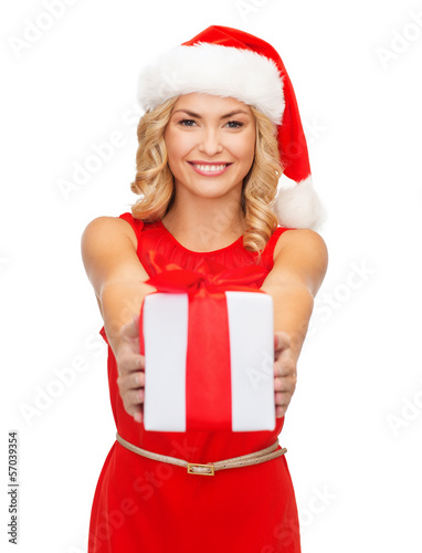 Photo: smiling woman in santa helper hat with gift box smiling woman in santa helper hat with gift box