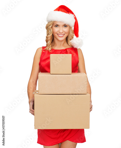 Photo: smiling woman in santa helper hat with parcels smiling woman in santa helper hat with parcels