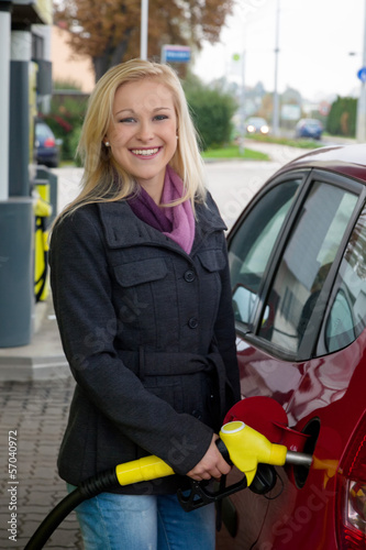 Photo: Frau beim tanken auf Tankstelle Frau beim tanken auf Tankstelle
