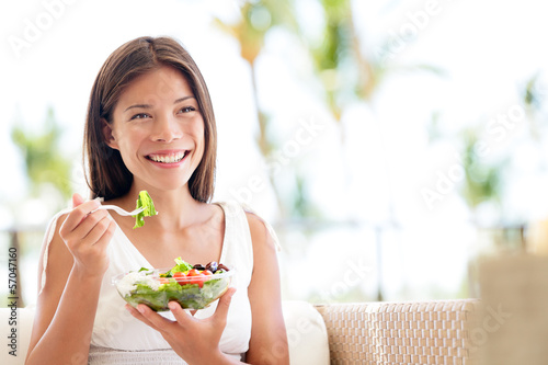 Photo: Healthy lifestyle woman eating salad smiling happy Healthy lifestyle woman eating salad smiling happy