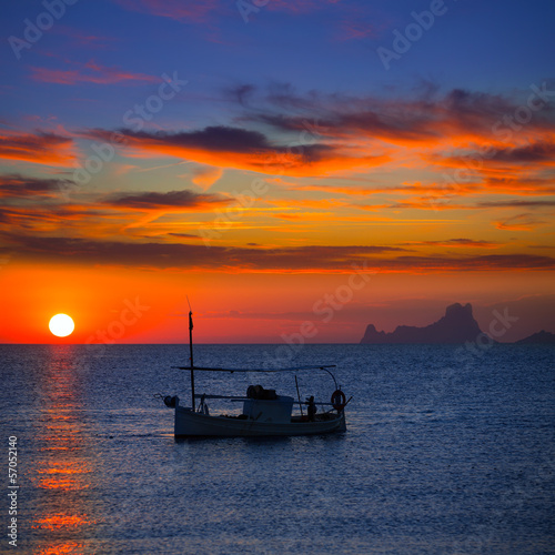 Photo: Ibiza sunset Es Vedra view and fisherboat formentera Ibiza sunset Es Vedra view and fisherboat formentera