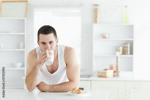 Photo: Attractive man having breakfast Attractive man having breakfast