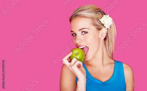 Photo: Beautiful woman biting into an apple Beautiful woman biting into an apple