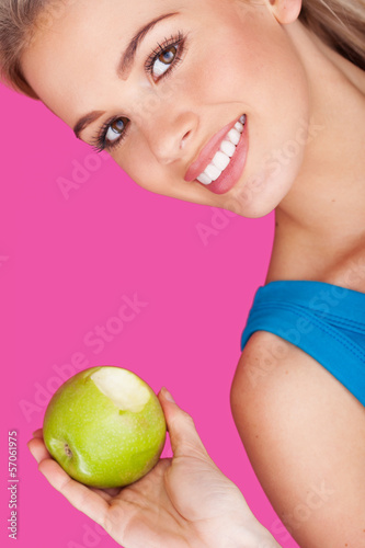 Photo: Smiling woman holding a bitten apple Smiling woman holding a bitten apple