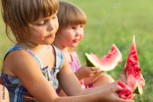 Photo: Girls eat sweet and tasty water-melon Girls eat sweet and tasty water-melon